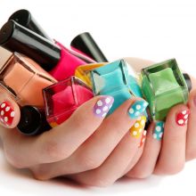 woman hands with nail polishes isolated on white